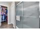 Modern shower with glass enclosure, towel rack, and neutral toned tile at 17162 N Winding Trl, Surprise, AZ 85374