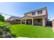 Backyard featuring artificial grass, covered patio, and string lights at 17425 W Willow Ave, Surprise, AZ 85388