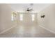 Spacious bedroom with neutral colors, large windows, tiled floor and a ceiling fan at 17425 W Willow Ave, Surprise, AZ 85388