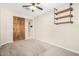 Bedroom featuring a barn door, carpet flooring, and built-in shelving at 17425 W Willow Ave, Surprise, AZ 85388