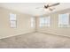 Bright, airy bedroom with large windows providing ample natural light and neutral carpeted flooring at 17425 W Willow Ave, Surprise, AZ 85388