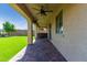 Covered patio showcasing brick floors and a view of the backyard with artificial grass and a hot tub at 17425 W Willow Ave, Surprise, AZ 85388