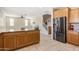 Open concept kitchen with stainless steel appliances and ample cabinet space flowing into living area at 17425 W Willow Ave, Surprise, AZ 85388