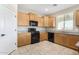 Bright kitchen with ample cabinetry, granite counters, and stainless sink and black appliances at 17425 W Willow Ave, Surprise, AZ 85388