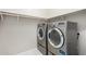 Modern laundry room featuring stainless steel washer and dryer set at 17425 W Willow Ave, Surprise, AZ 85388