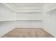 Spacious walk-in closet with carpet flooring and multiple shelves and clothing rods at 17425 W Willow Ave, Surprise, AZ 85388