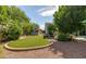 This backyard has artificial turf, gravel beds, and a mural on the shed for outdoor enjoyment at 1810 N Sunaire Cir, Mesa, AZ 85205
