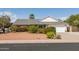 Charming single-story home with a well-maintained front yard, mature trees, and a two-car garage at 1810 N Sunaire Cir, Mesa, AZ 85205