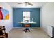 Versatile room with a built-in desk, chair, and bright light; ideal for a home office or a creative space at 1810 N Sunaire Cir, Mesa, AZ 85205