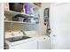 Functional laundry room with modern appliances, ample shelving, and storage options for organization at 1810 N Sunaire Cir, Mesa, AZ 85205