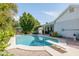 A sparkling pool with diving board is set in a private backyard oasis with mature landscaping at 1810 N Sunaire Cir, Mesa, AZ 85205