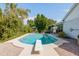 A sparkling pool with diving board is set in a private backyard oasis with mature landscaping at 1810 N Sunaire Cir, Mesa, AZ 85205
