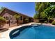 Exterior view of home, pool and patio in a well-maintained backyard at 18492 E Oak Hill Ln, Queen Creek, AZ 85142