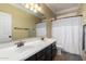 Bright bathroom with a double sink vanity, large mirror, and a shower and tub at 18492 E Oak Hill Ln, Queen Creek, AZ 85142