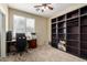 Functional bedroom featuring carpet floors, built-in shelving, and a ceiling fan at 18492 E Oak Hill Ln, Queen Creek, AZ 85142