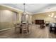 Elegant dining area with wood flooring, stylish lighting fixture, and modern decor at 18492 E Oak Hill Ln, Queen Creek, AZ 85142