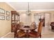 Cozy dining area featuring a round table with seating for four and classic china cabinet at 18492 E Oak Hill Ln, Queen Creek, AZ 85142