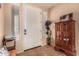 Inviting entryway with decorative tiled floors, a white front door, and natural lighting at 18492 E Oak Hill Ln, Queen Creek, AZ 85142