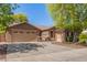 Warm single-story home featuring a three car garage and a well-manicured yard at 18492 E Oak Hill Ln, Queen Creek, AZ 85142