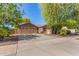 Charming home with a three-car garage, manicured lawn, and lush trees, offering great curb appeal at 18492 E Oak Hill Ln, Queen Creek, AZ 85142