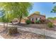 Lovely single-story home featuring dark shutters and a beautifully landscaped front yard at 18492 E Oak Hill Ln, Queen Creek, AZ 85142