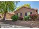 Single-story home with black shutters and mature landscaping, boosting its curb appeal at 18492 E Oak Hill Ln, Queen Creek, AZ 85142