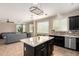 Open concept kitchen with island, stainless appliances, and views of living area at 18492 E Oak Hill Ln, Queen Creek, AZ 85142