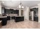 Modern kitchen with black cabinets, stainless steel appliances, and center island at 18492 E Oak Hill Ln, Queen Creek, AZ 85142