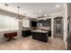 Modern kitchen with dark cabinets, an island, and updated appliances at 18492 E Oak Hill Ln, Queen Creek, AZ 85142