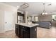Open concept kitchen with a central island connecting to the adjacent living space at 18492 E Oak Hill Ln, Queen Creek, AZ 85142