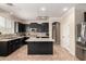Spacious kitchen featuring dark cabinetry, stainless steel appliances, and tile backsplash at 18492 E Oak Hill Ln, Queen Creek, AZ 85142