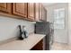 Well-organized laundry room with overhead cabinets, folding counter, and modern washer and dryer at 18492 E Oak Hill Ln, Queen Creek, AZ 85142