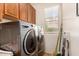 Well lit laundry room with new washer and dryer at 18492 E Oak Hill Ln, Queen Creek, AZ 85142