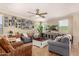 Comfortable living room features modern ceiling fan, neutral tones, and hardwood floors at 18492 E Oak Hill Ln, Queen Creek, AZ 85142
