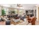Open concept living room with stylish furnishings, ceiling fan, and views of kitchen at 18492 E Oak Hill Ln, Queen Creek, AZ 85142