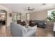 Inviting living room with hardwood floors, neutral paint, ceiling fan, and lots of natural light at 18492 E Oak Hill Ln, Queen Creek, AZ 85142