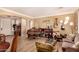 Inviting living room with elegant furnishings, wood flooring, and lots of natural light at 18492 E Oak Hill Ln, Queen Creek, AZ 85142