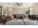 Cozy living room with ceiling fan, comfortable seating, and ample natural light at 18492 E Oak Hill Ln, Queen Creek, AZ 85142