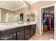 Well-appointed main bathroom boasts double sink vanity and access to walk-in closet at 18492 E Oak Hill Ln, Queen Creek, AZ 85142
