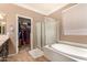Relaxing main bathroom with soaking tub and walk-in shower, next to walk-in closet at 18492 E Oak Hill Ln, Queen Creek, AZ 85142