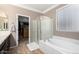 Spacious main bathroom with separate bathtub and shower, and walk in closet at 18492 E Oak Hill Ln, Queen Creek, AZ 85142