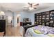 Bright main bedroom with wood floors, large bed, and views of the walk-in closet at 18492 E Oak Hill Ln, Queen Creek, AZ 85142