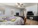 Comfortable main bedroom with hardwood floors and a large television at 18492 E Oak Hill Ln, Queen Creek, AZ 85142