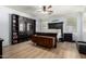 Spacious main bedroom featuring hardwood floors, black furniture, and lots of natural light at 18492 E Oak Hill Ln, Queen Creek, AZ 85142