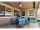 Outdoor patio with seating, ceiling fan, and shade, perfect for entertaining guests at 18492 E Oak Hill Ln, Queen Creek, AZ 85142