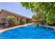 Stunning pool area surrounded by mature trees, offering a private retreat at 18492 E Oak Hill Ln, Queen Creek, AZ 85142