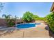 Inviting private pool with rock accents and lush landscaping, creating a serene backyard oasis at 18492 E Oak Hill Ln, Queen Creek, AZ 85142
