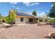 Spacious backyard with low maintenance landscaping and solar panels on the roof, under a clear blue sky at 18802 N 71St Ln, Glendale, AZ 85308
