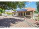 This backyard features desert landscaping, a covered patio, and solar panels on the roof at 18802 N 71St Ln, Glendale, AZ 85308