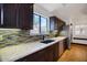 Stylish kitchen featuring granite countertops, stainless steel appliances, and mosaic tile backsplash at 18802 N 71St Ln, Glendale, AZ 85308